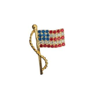 Patriotic gold-tone American flag brooch featuring red, white, and blue rhinesto